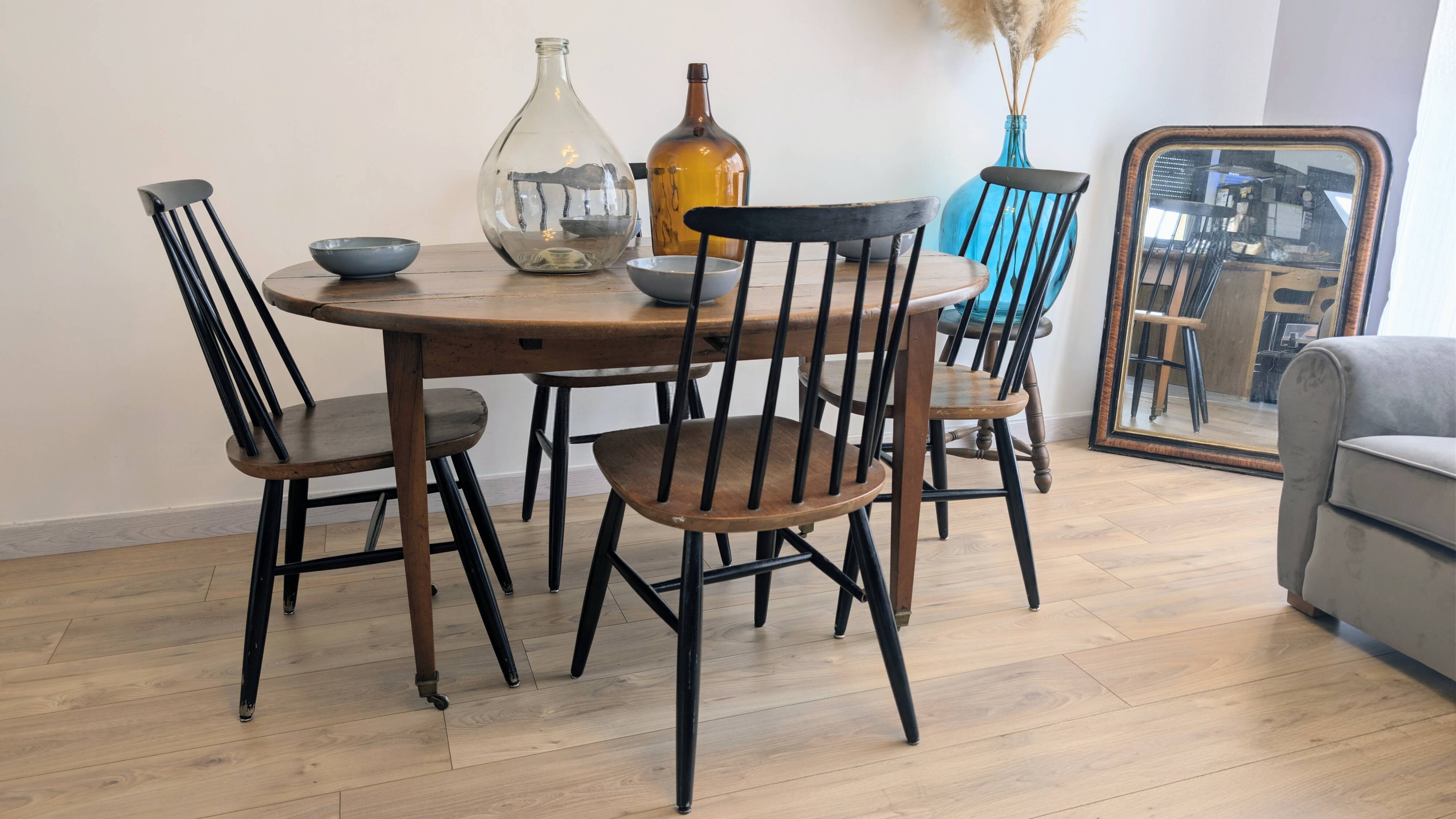 Antique wooden folding table with a patina and brass wheels.