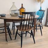 Antique wooden folding table with a patina and brass wheels.