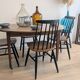 Antique wooden folding table with a patina and brass wheels.