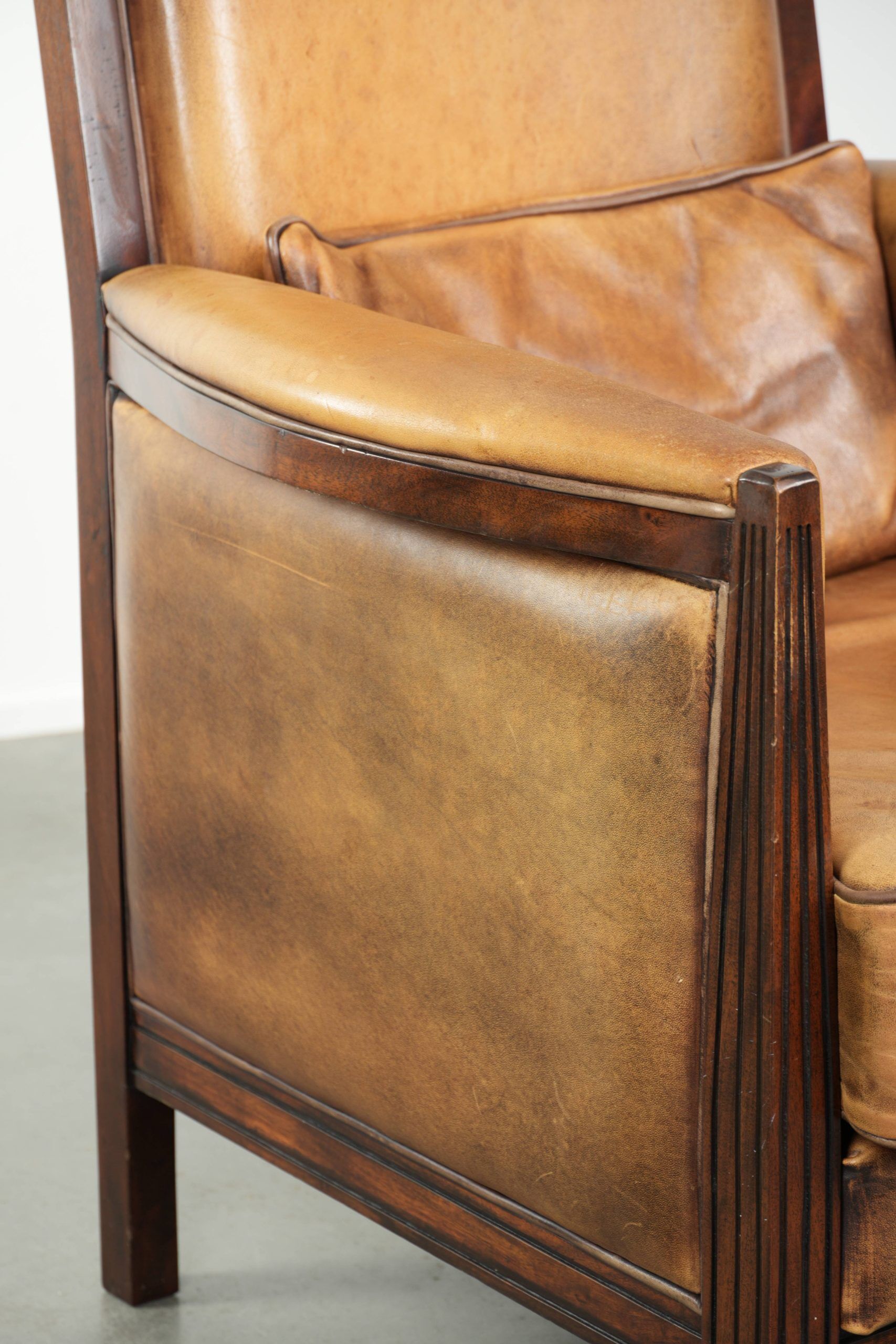 Cognac-coloured Art Deco design armchair made of sheepskin with a high back