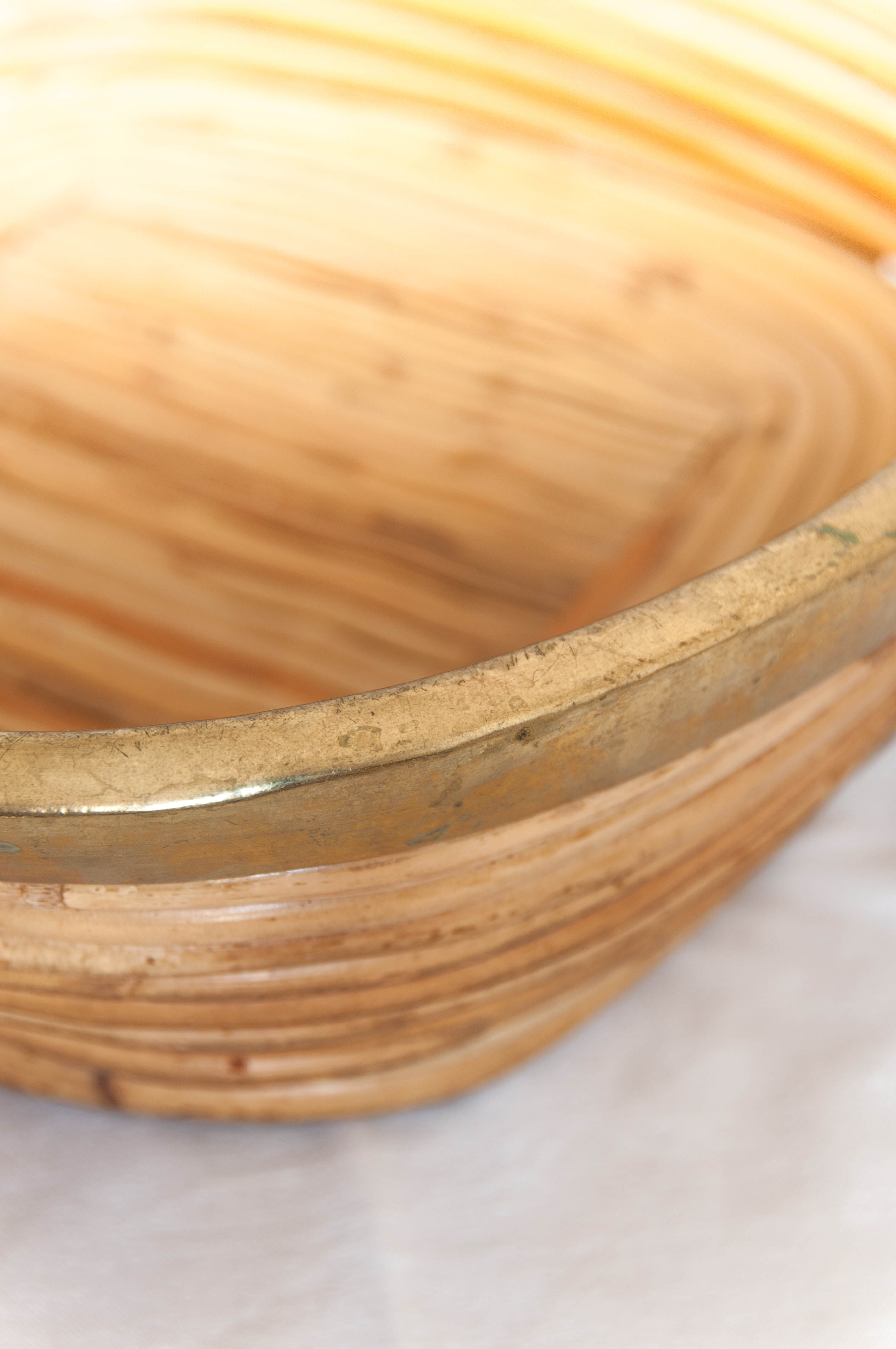 Vintage brass-rimmed rattan basket