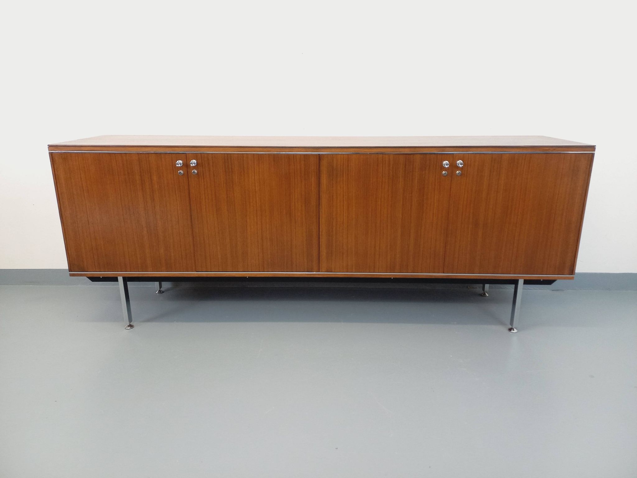 Vintage modernist enfilade in rosewood and chrome metal from the 60s and 70s.