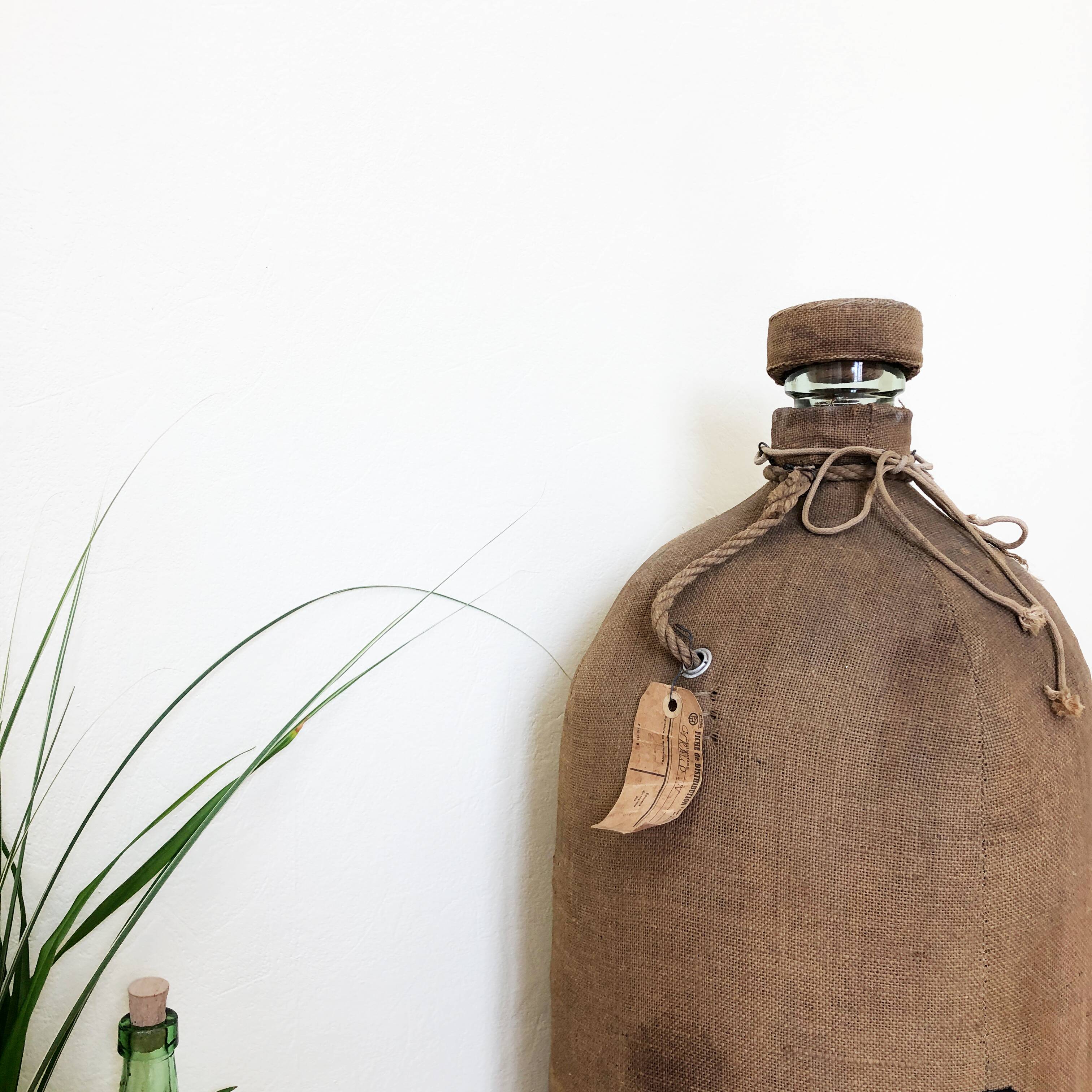 Big demijohn with burlap
