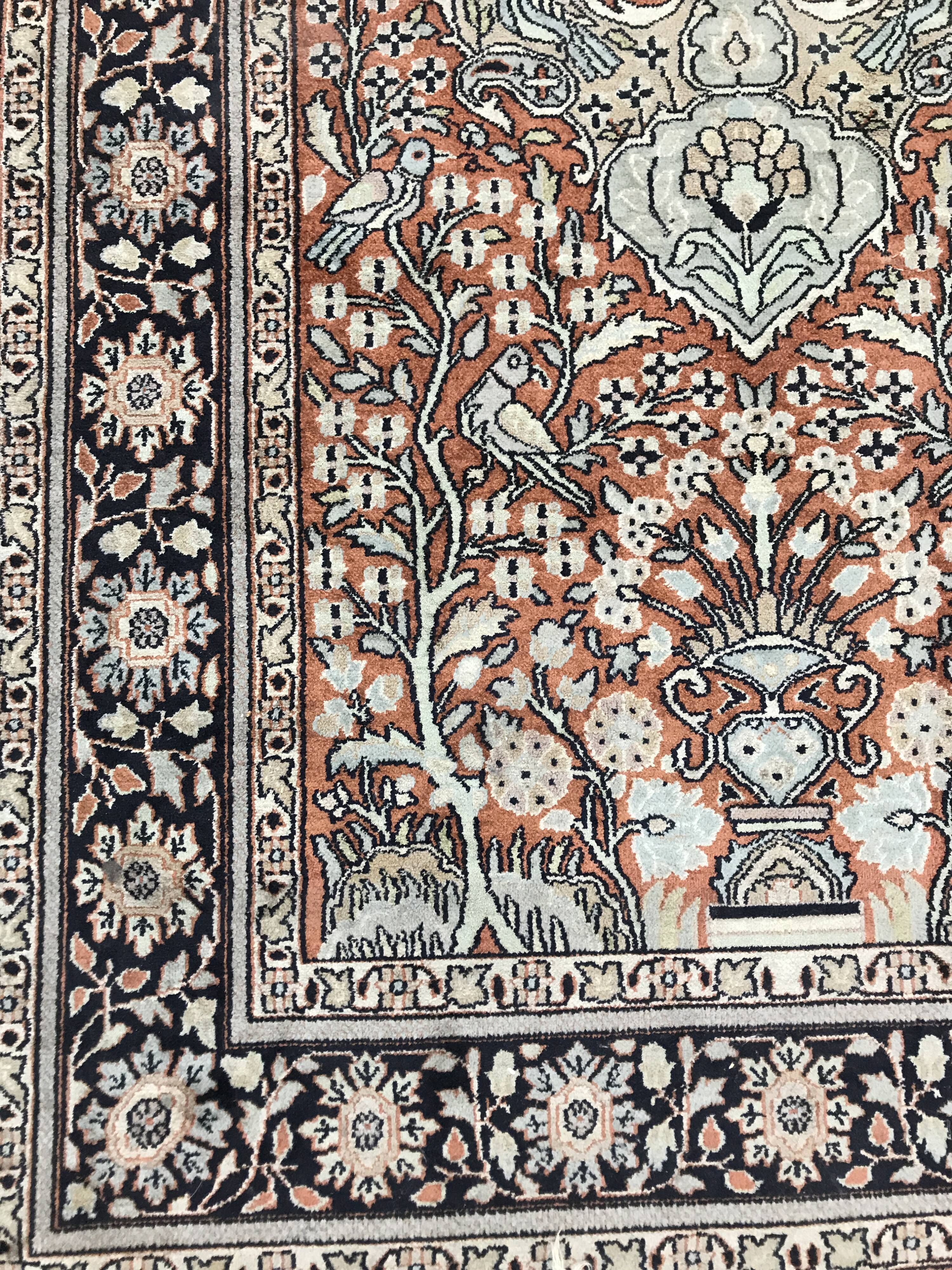 Wool and silk rug with a vegetated décor on a pink background, blue-bottomed border 157 x 91 cm