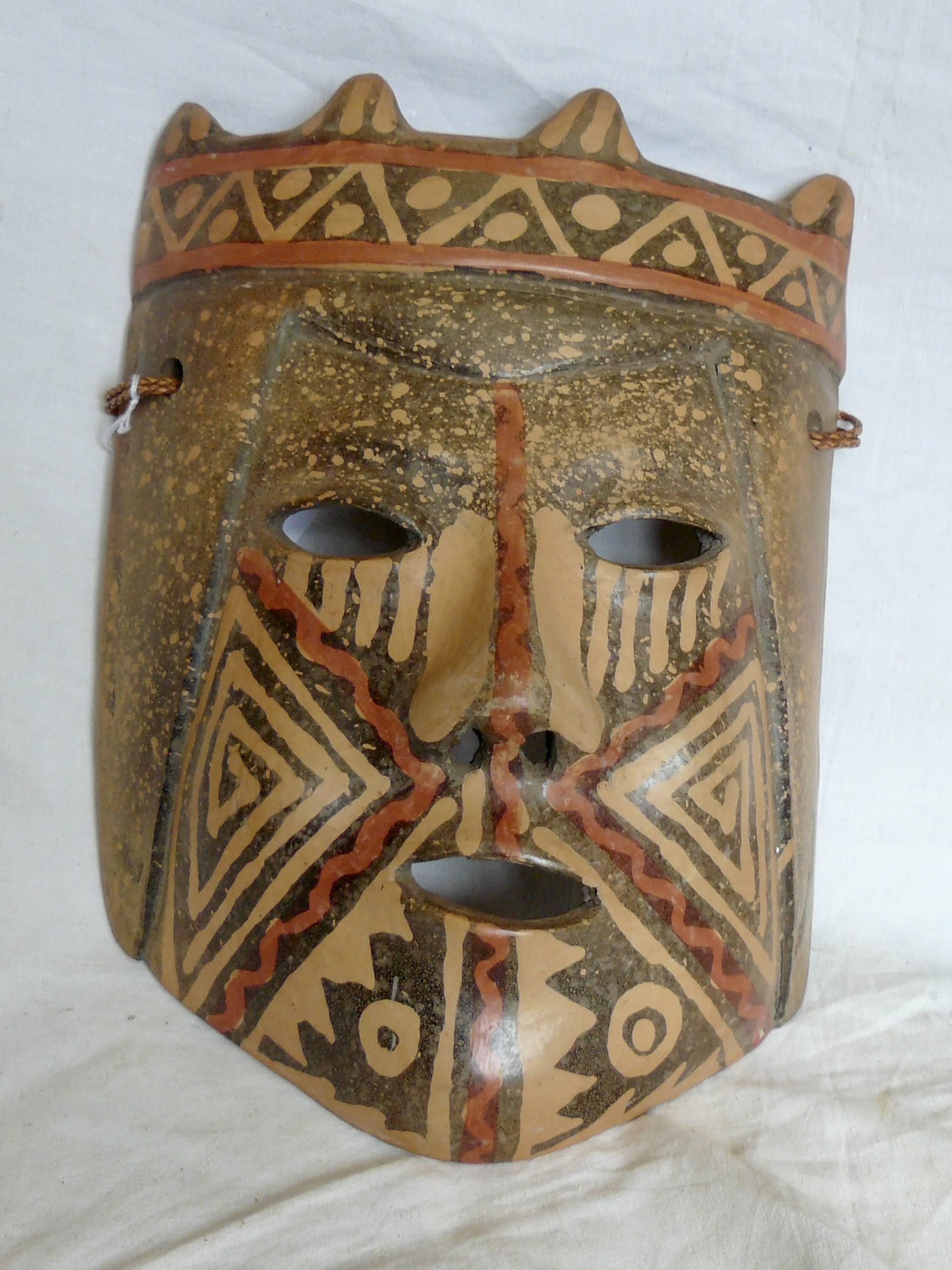 Terracotta mask with geometric decorations