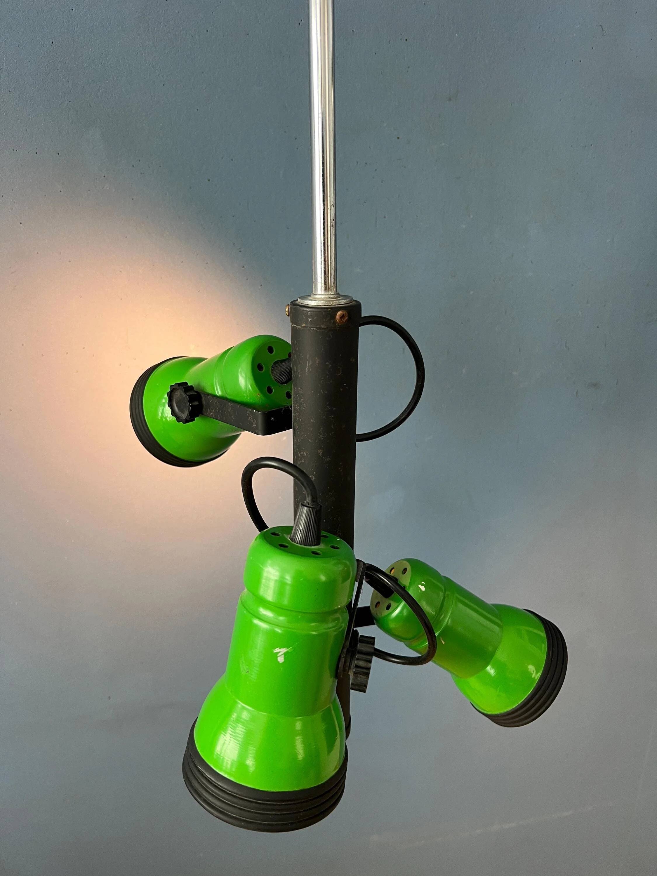 Vintage pendant light with three green spots.