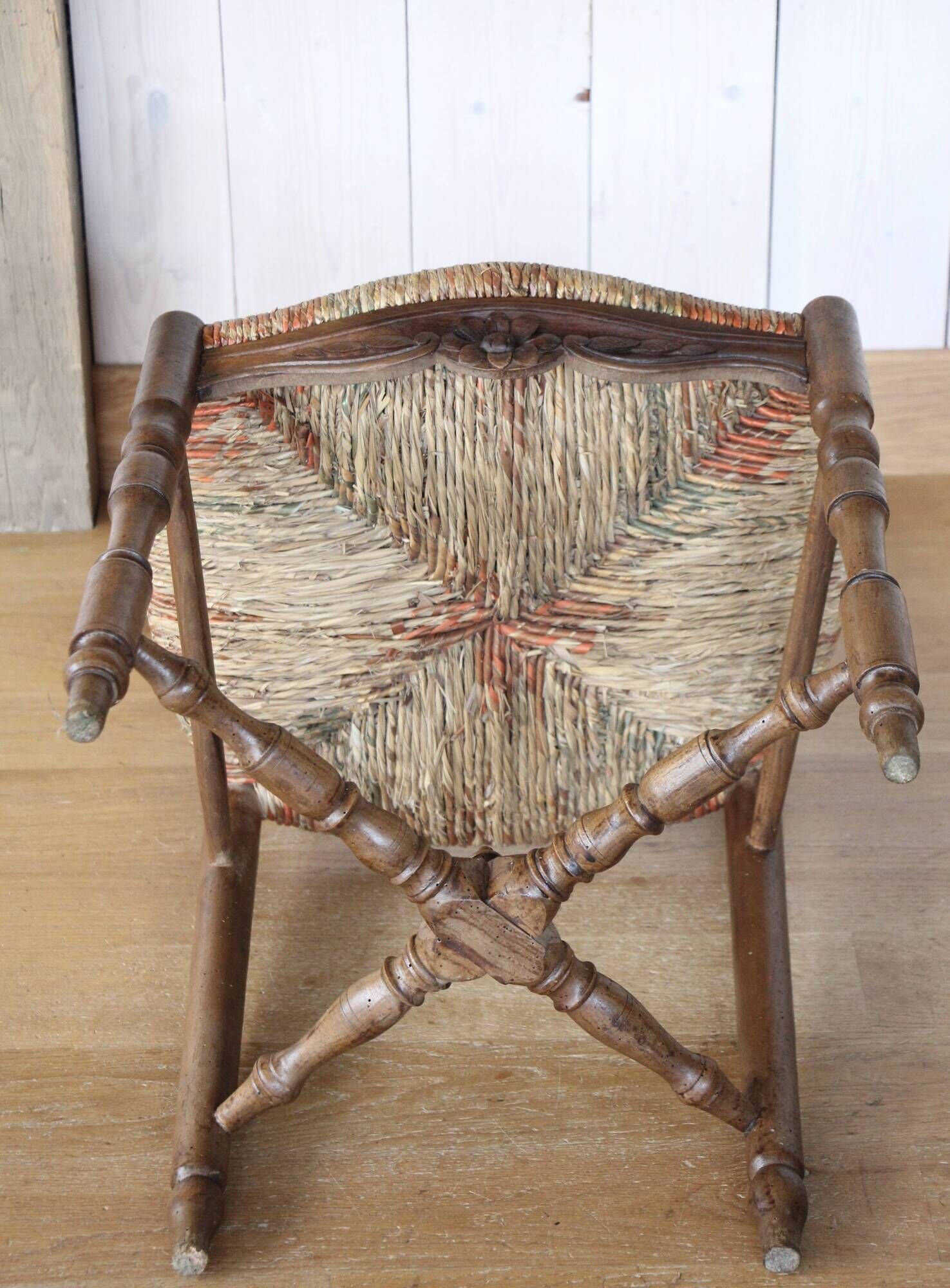 Antique chair with coloured rush seating.