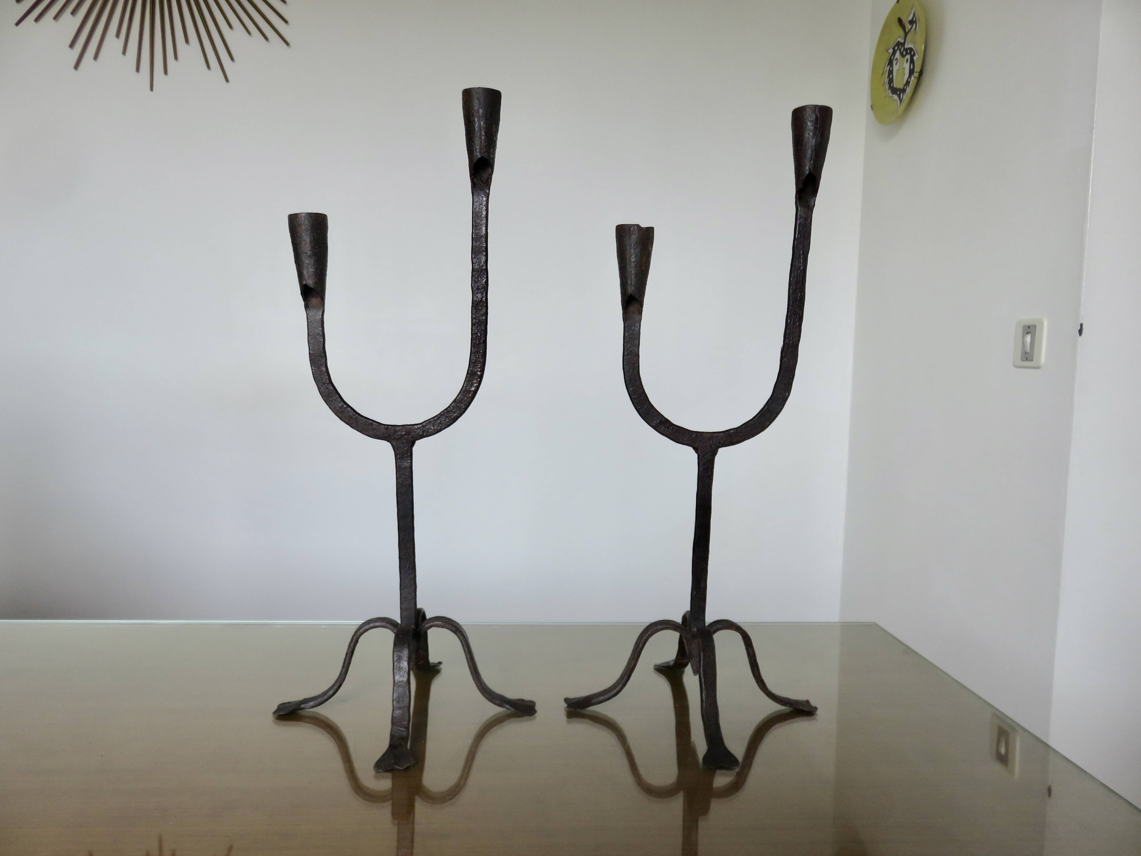 Pair of antique wrought iron candlesticks