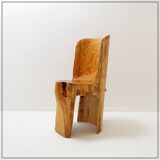 Brutalist sculptural chair in solid oak in wabi-sabi style.
