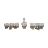 Old glass liquor service and golden border with its decanter and 10 vintage glasses