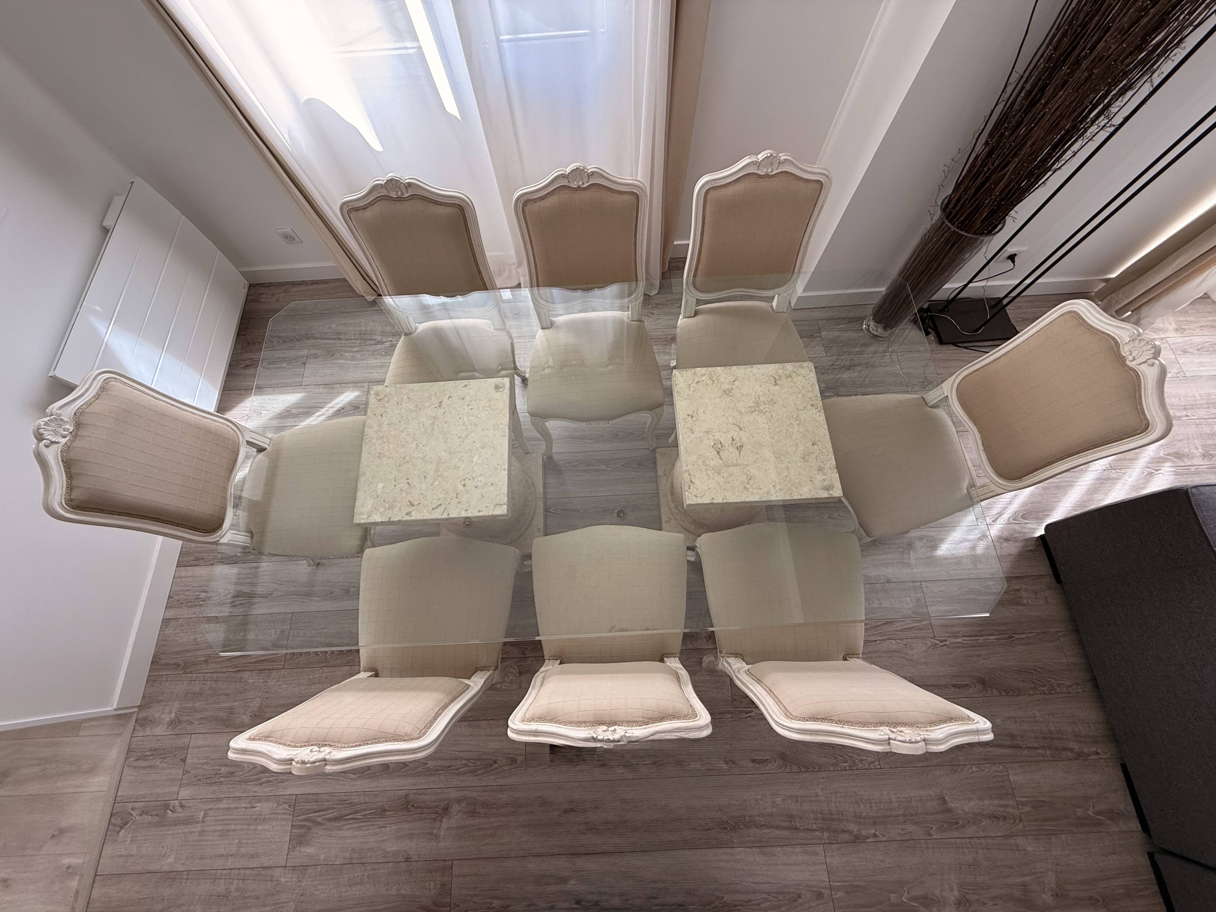 Table with a glass top and 8 chairs.