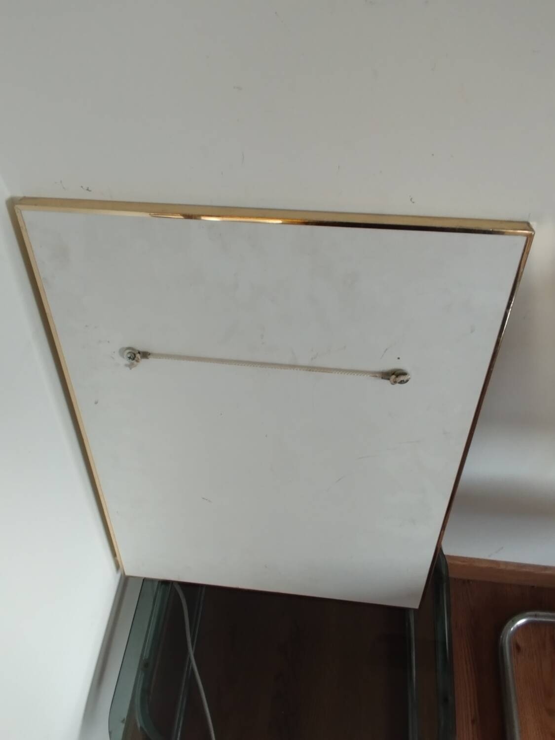 Vintage mirror in gilded brass and smoked glass. circa 1970