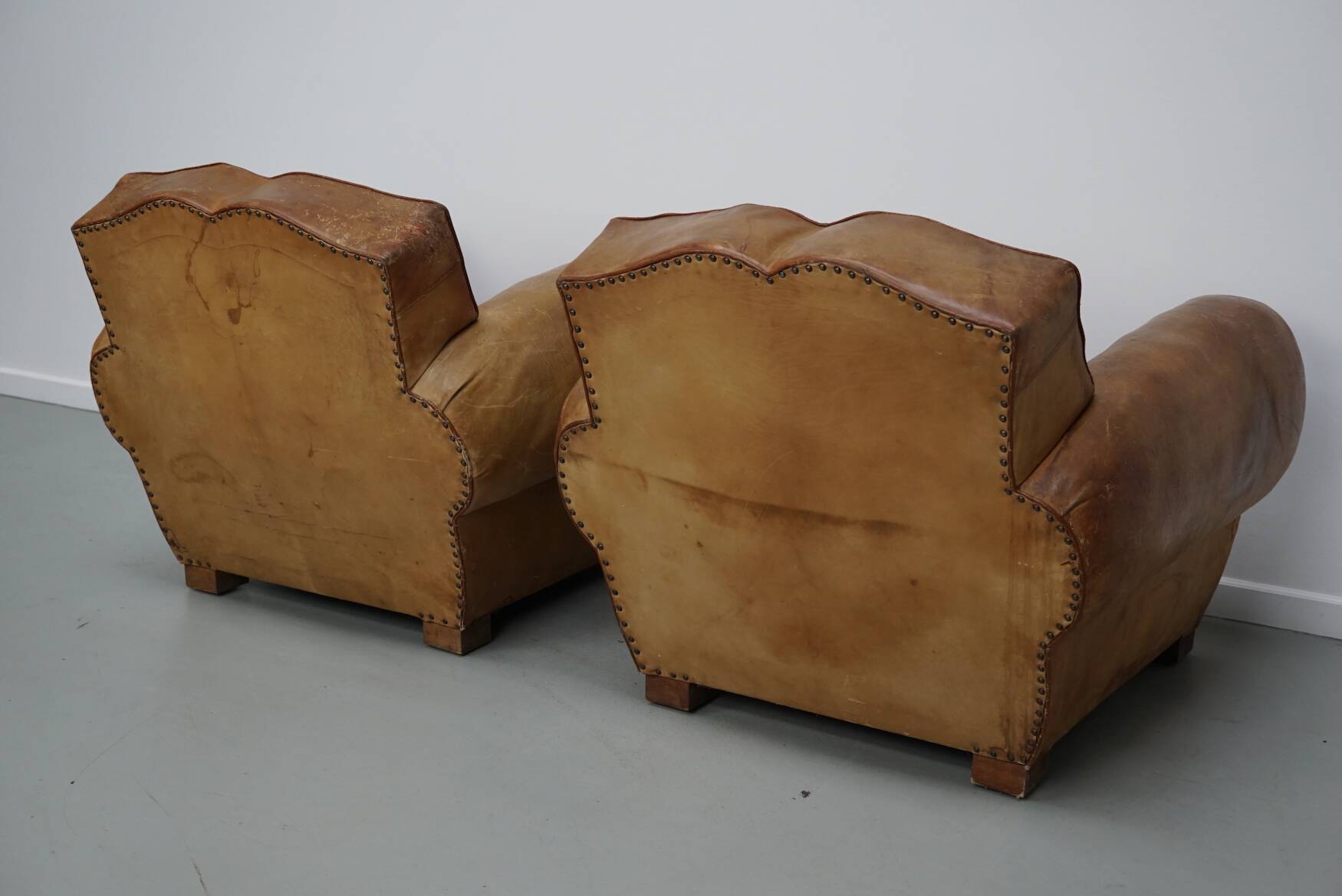 Pair of French club chairs with moustache back in cognac leather, 1940s