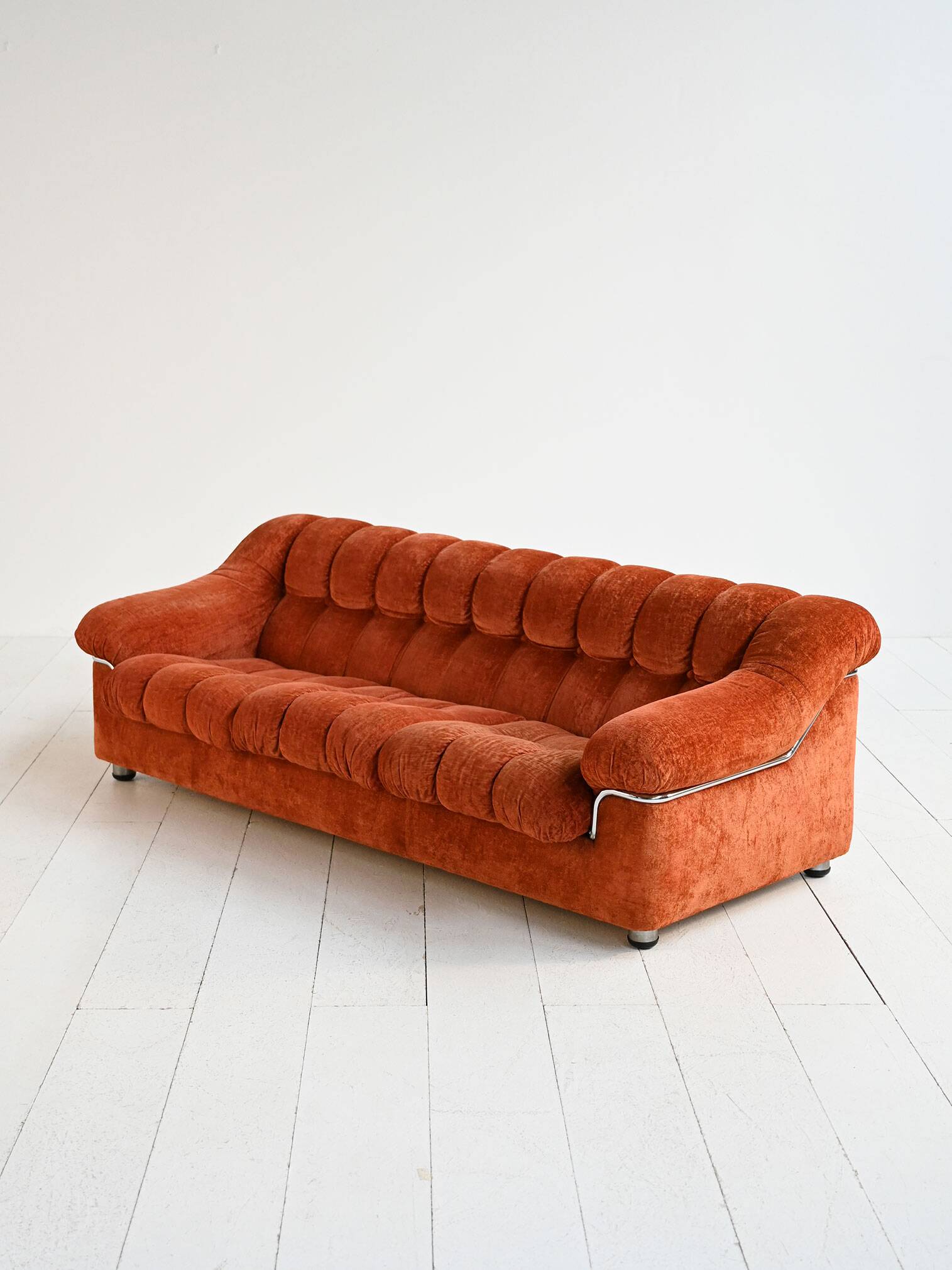Vintage rust velvet sofa from the 1970s with metal details.