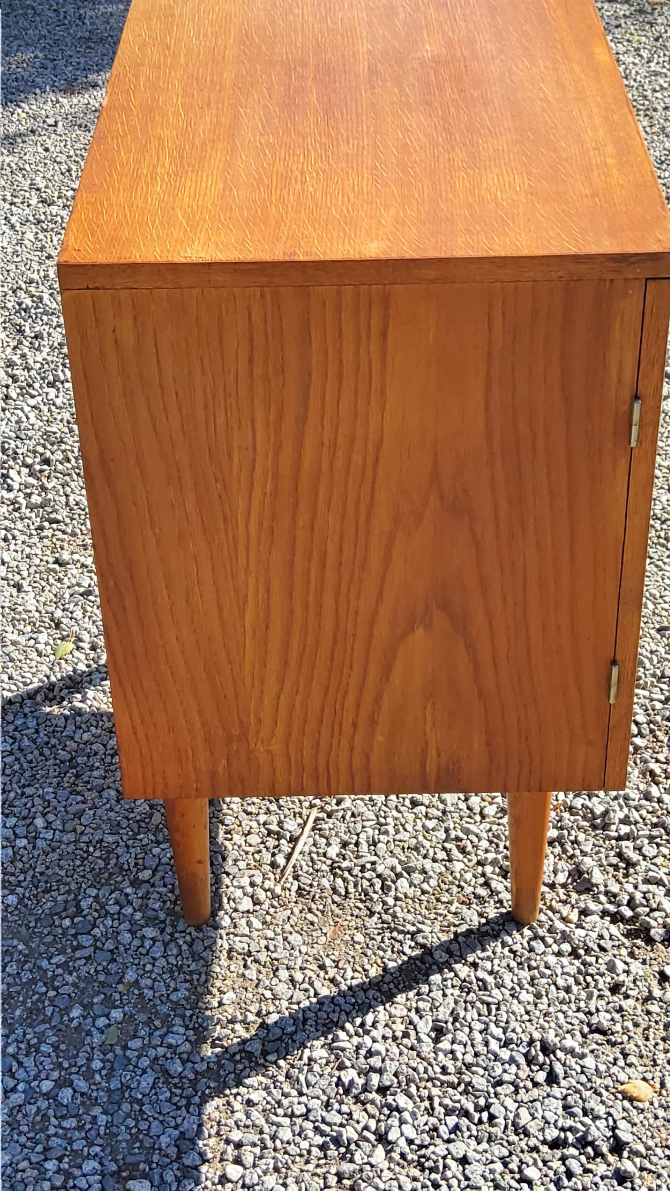 Vintage golden oak sideboard with conical legs from the 1950s