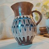 Pitcher with ethnic decorations