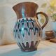 Pitcher with ethnic decorations