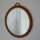 Small round mirror with rattan frame, vintage 70s