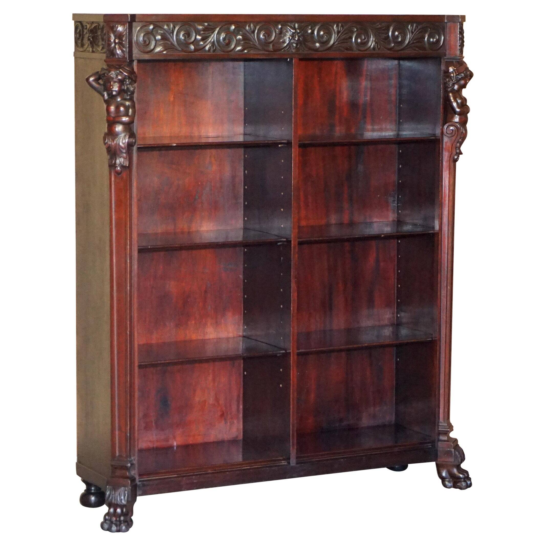 Hand-carved library circa 1900 in hardwood with Hermes statues.