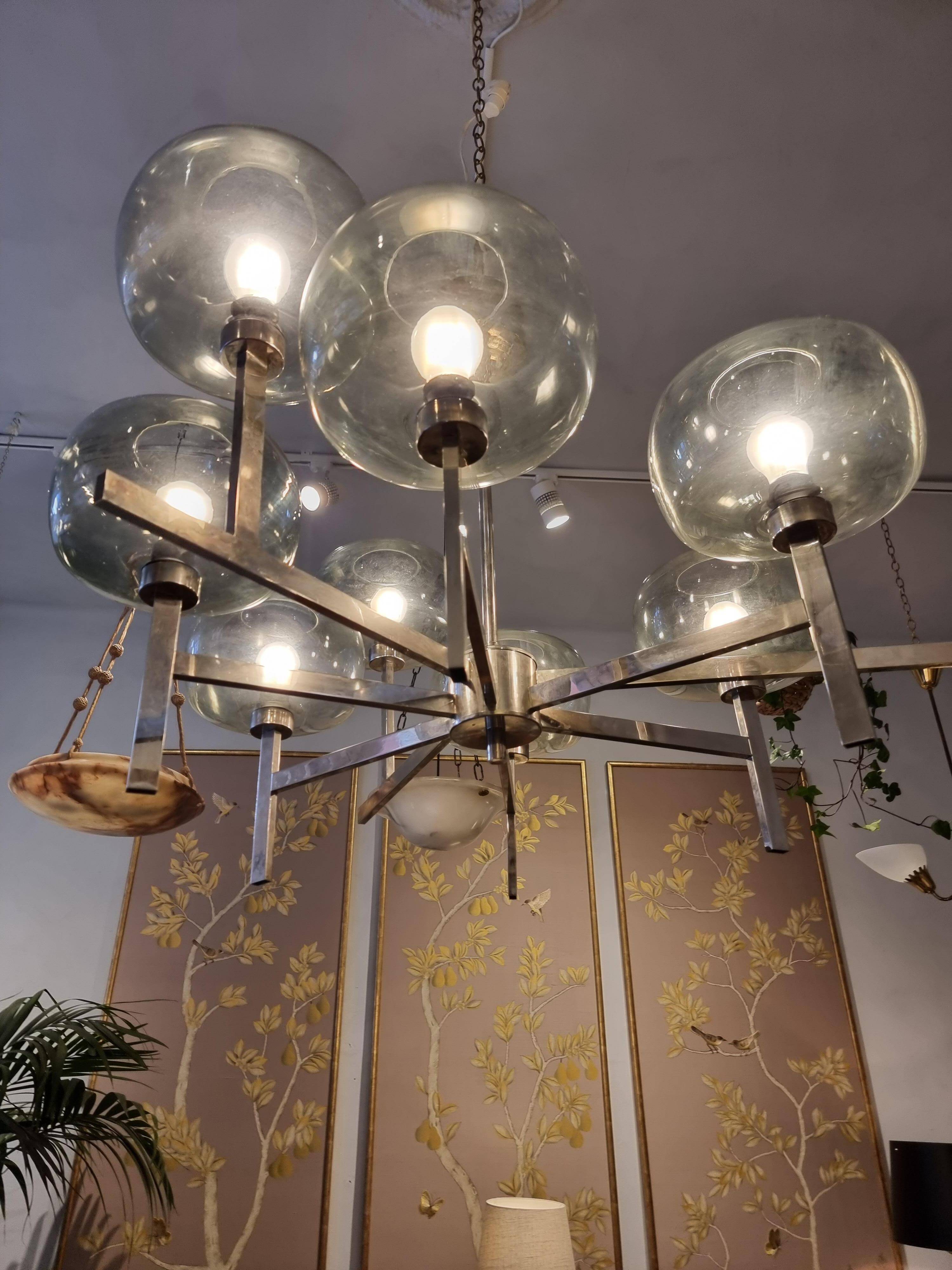 Timeless modern Scandinavian / mid-century chandelier in chrome and smoked glass.