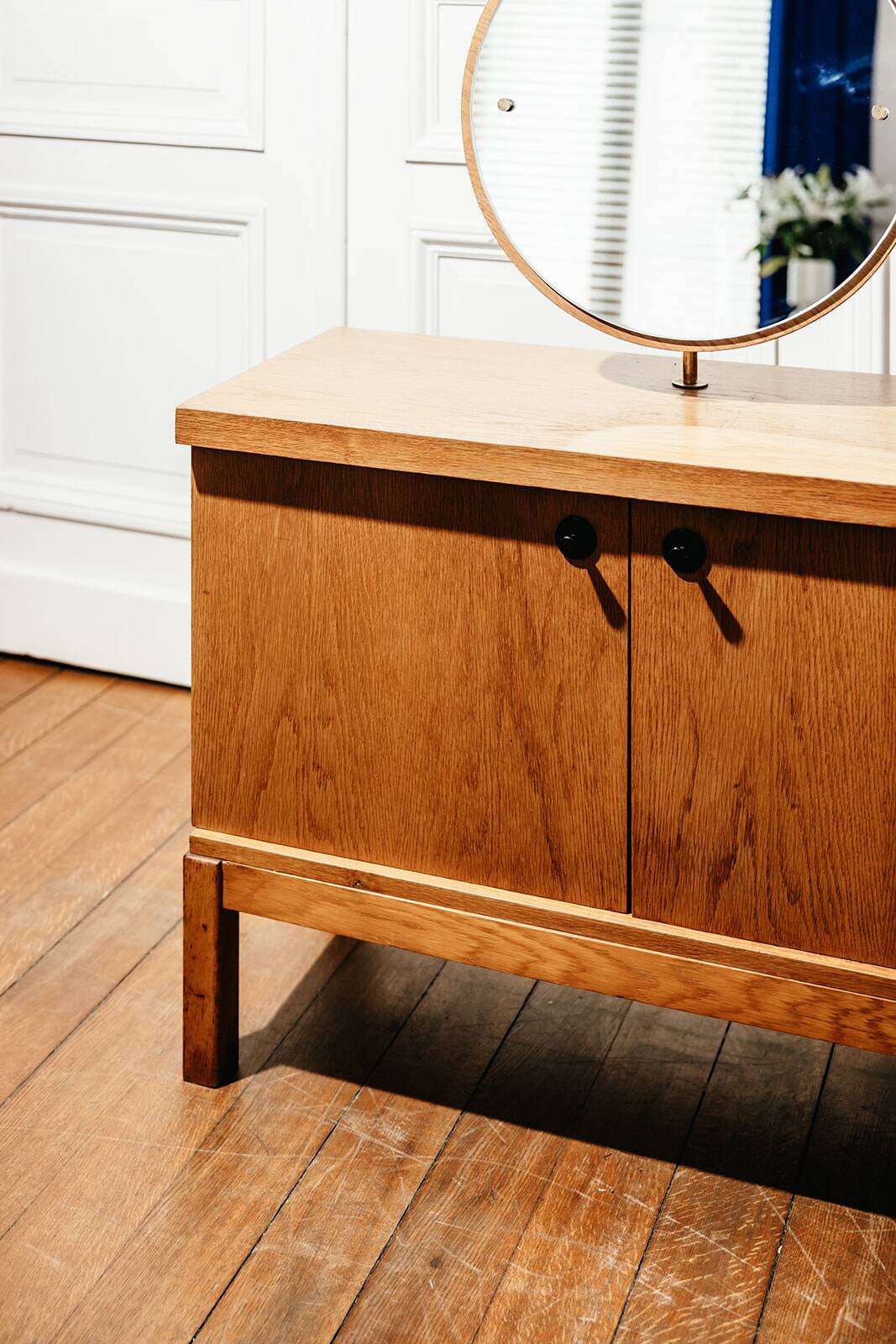 Vintage oak cabinet with circular mirror, 1960s modernist design.