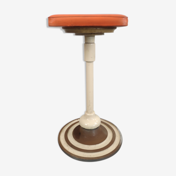 Old swivel orange sitting dentist stool