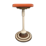 Old swivel orange sitting dentist stool