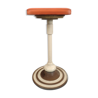 Old swivel orange sitting dentist stool