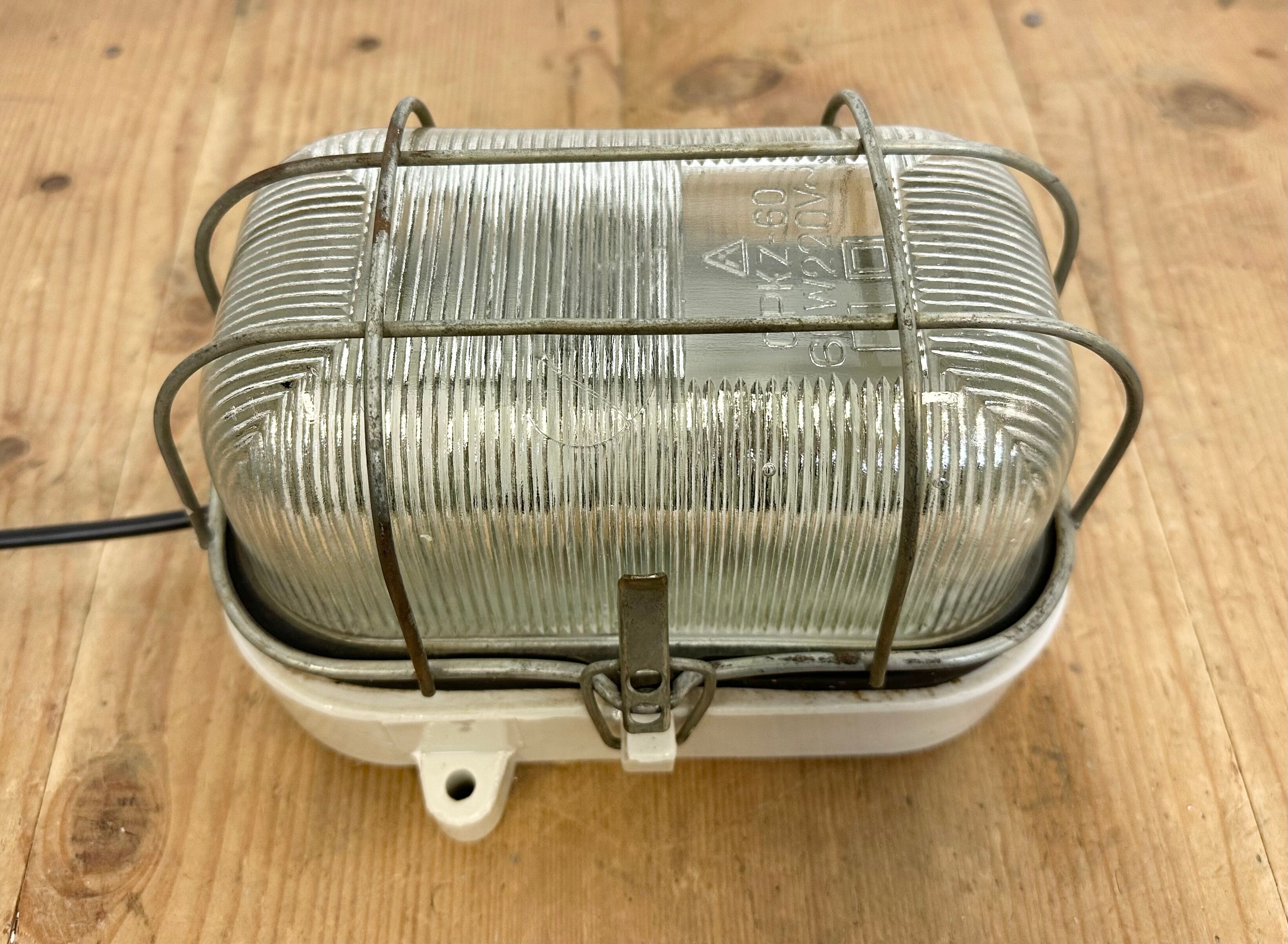 Industrial white porcelain cage wall light with ribbed glass, 1970s