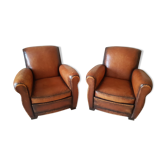 Paire de fauteuil club en cuir cognac patiné et usé