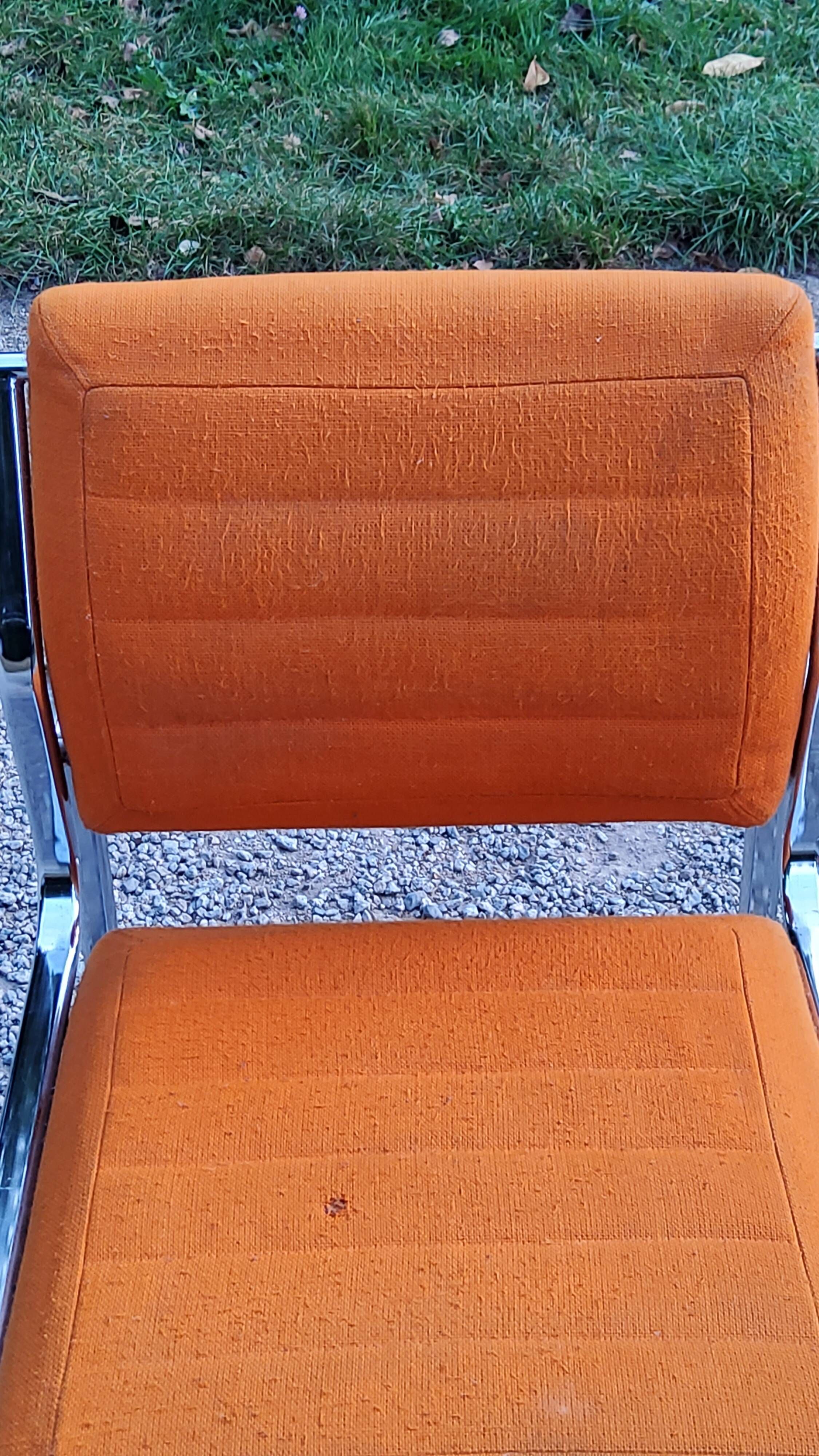 Pair of designer armchairs in orange fabrics and chrome tubes from the 70s