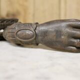 Antique cast iron door knocker in the shape of a 19th century hand