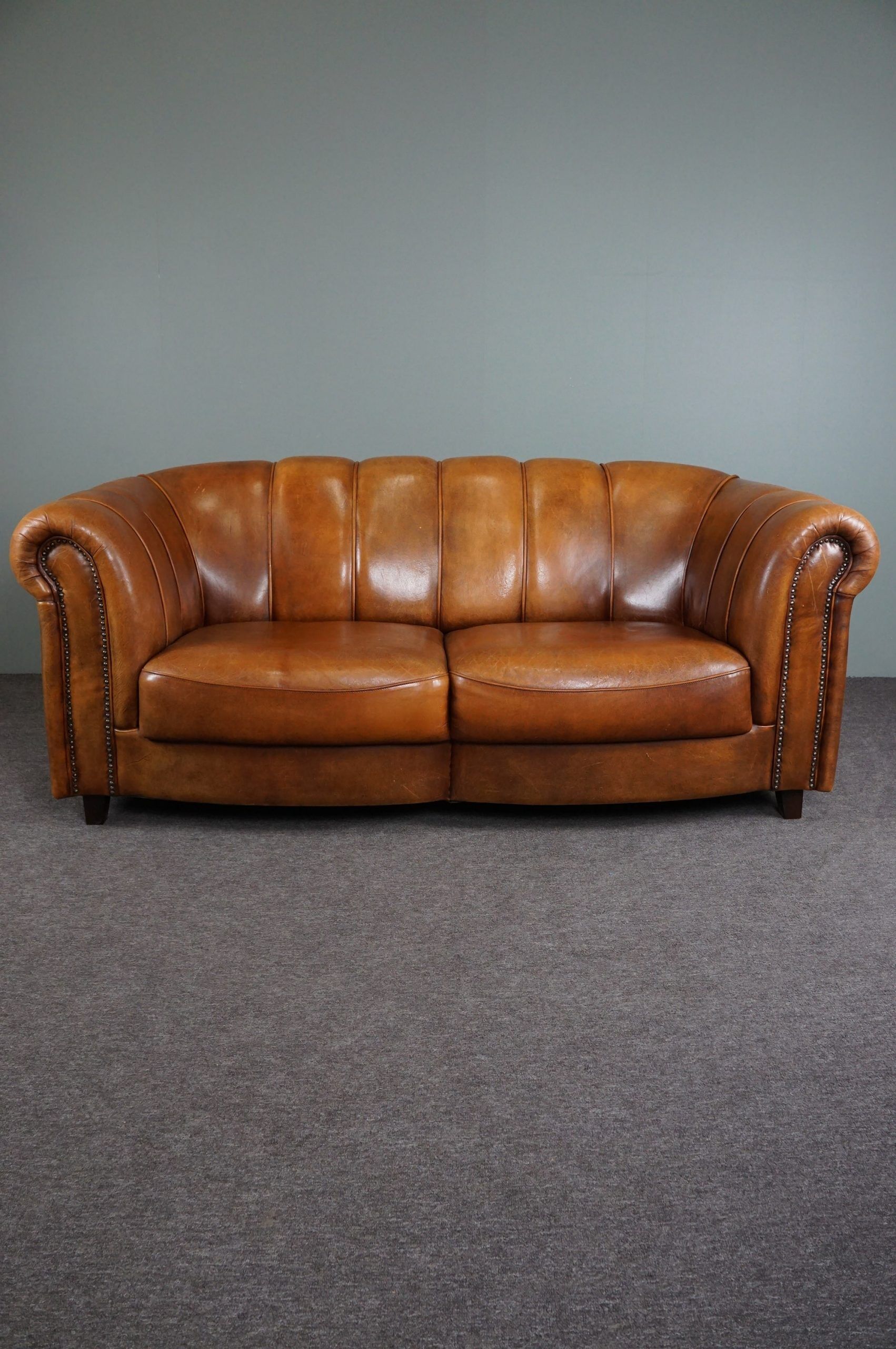 Sheepskin sofa with decorative nails