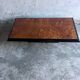 Vintage coffee table in wood burl on a black lacquered base.