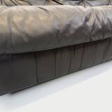 Vintage corner sofa composed of 3 modules in black leather with integrated bed.