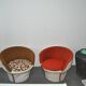 Set of 2 vintage 1970s tub chairs in brown, red, and white fabric with a enveloping silhouette.