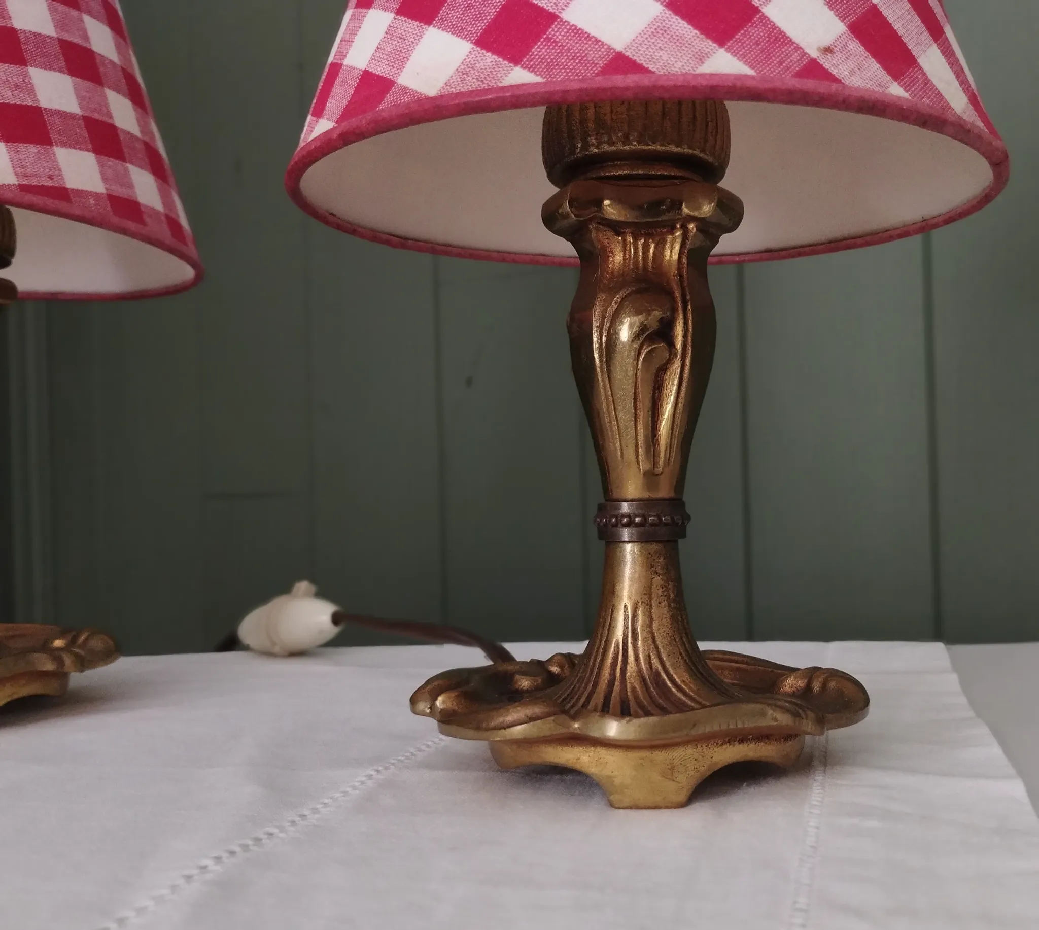 Pair of small lamps in gilded bronze by Petitot and red gingham lampshades.