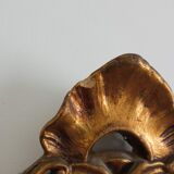 Old wooden mirror and gilded stucco