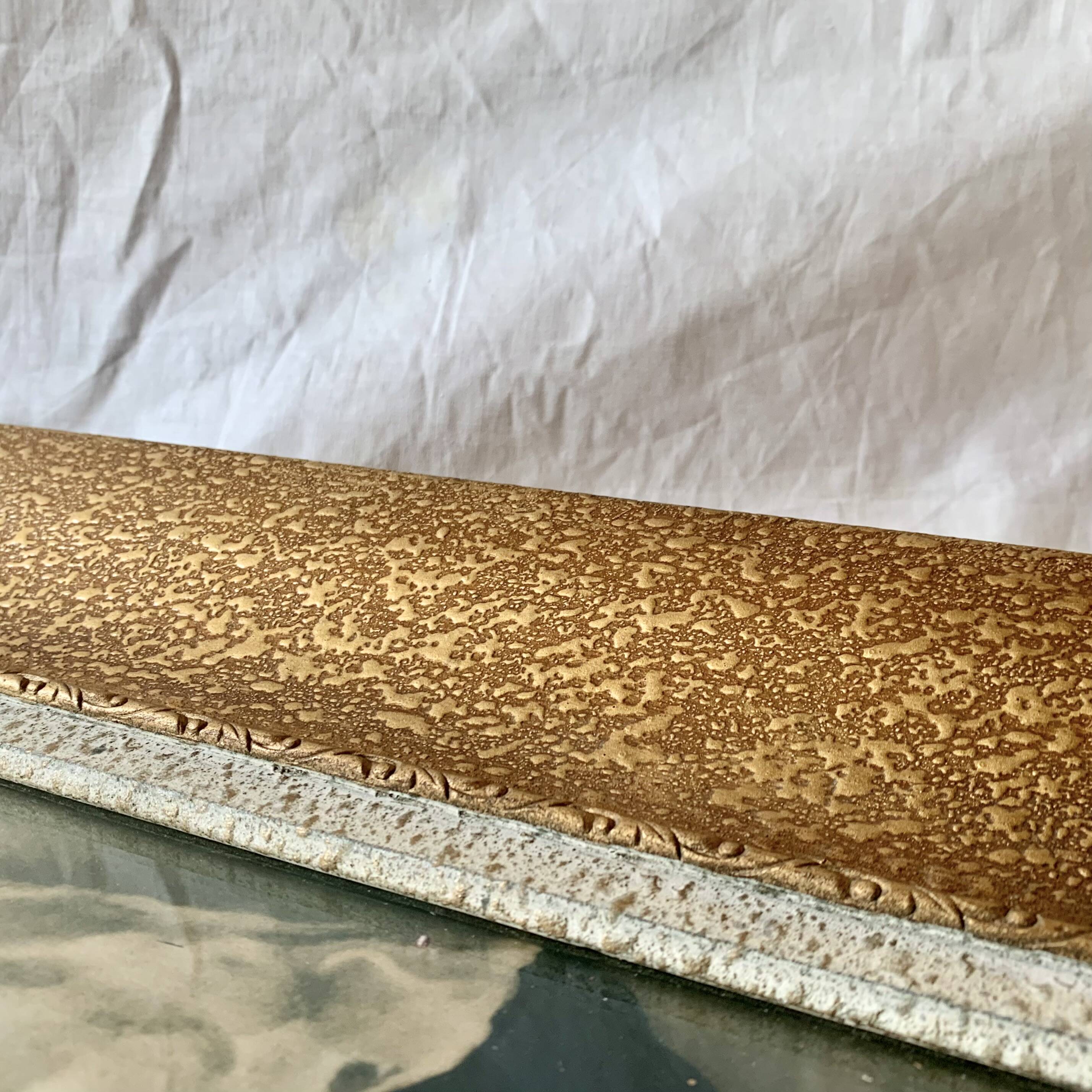 Old wall frame in carved gilded wood