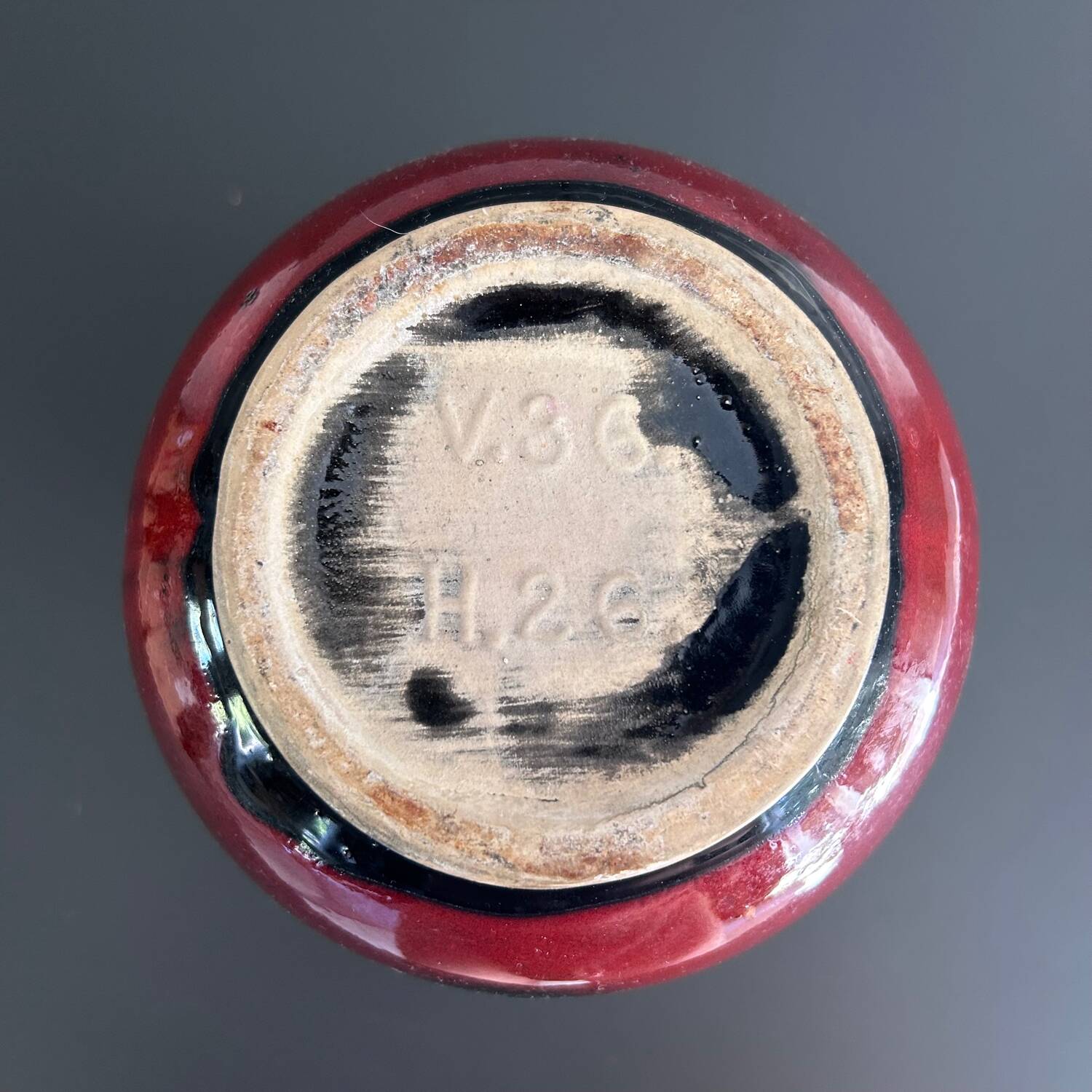 Red vase with floral decoration