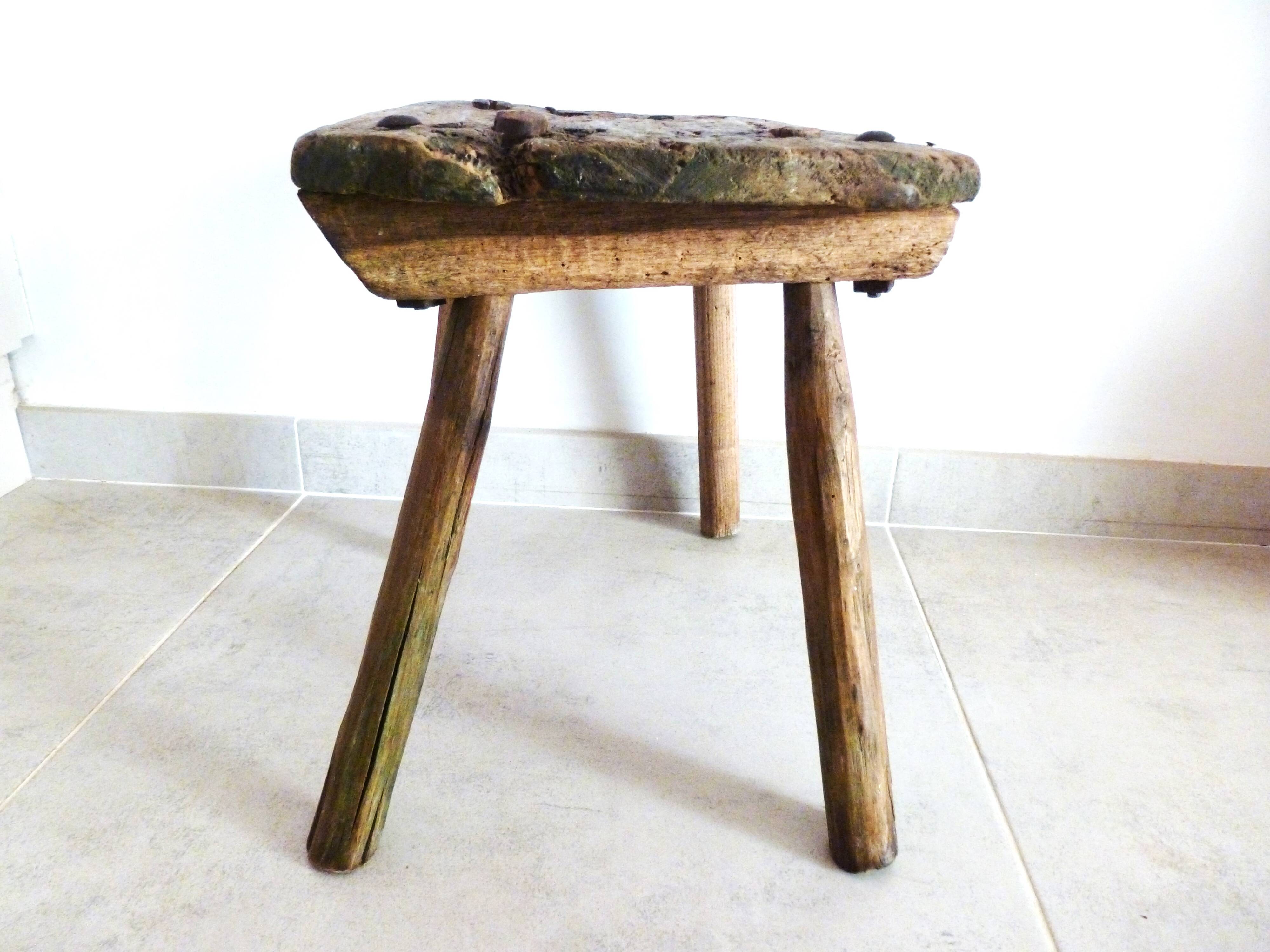 Old milking stool, old farm stool, primitive art.