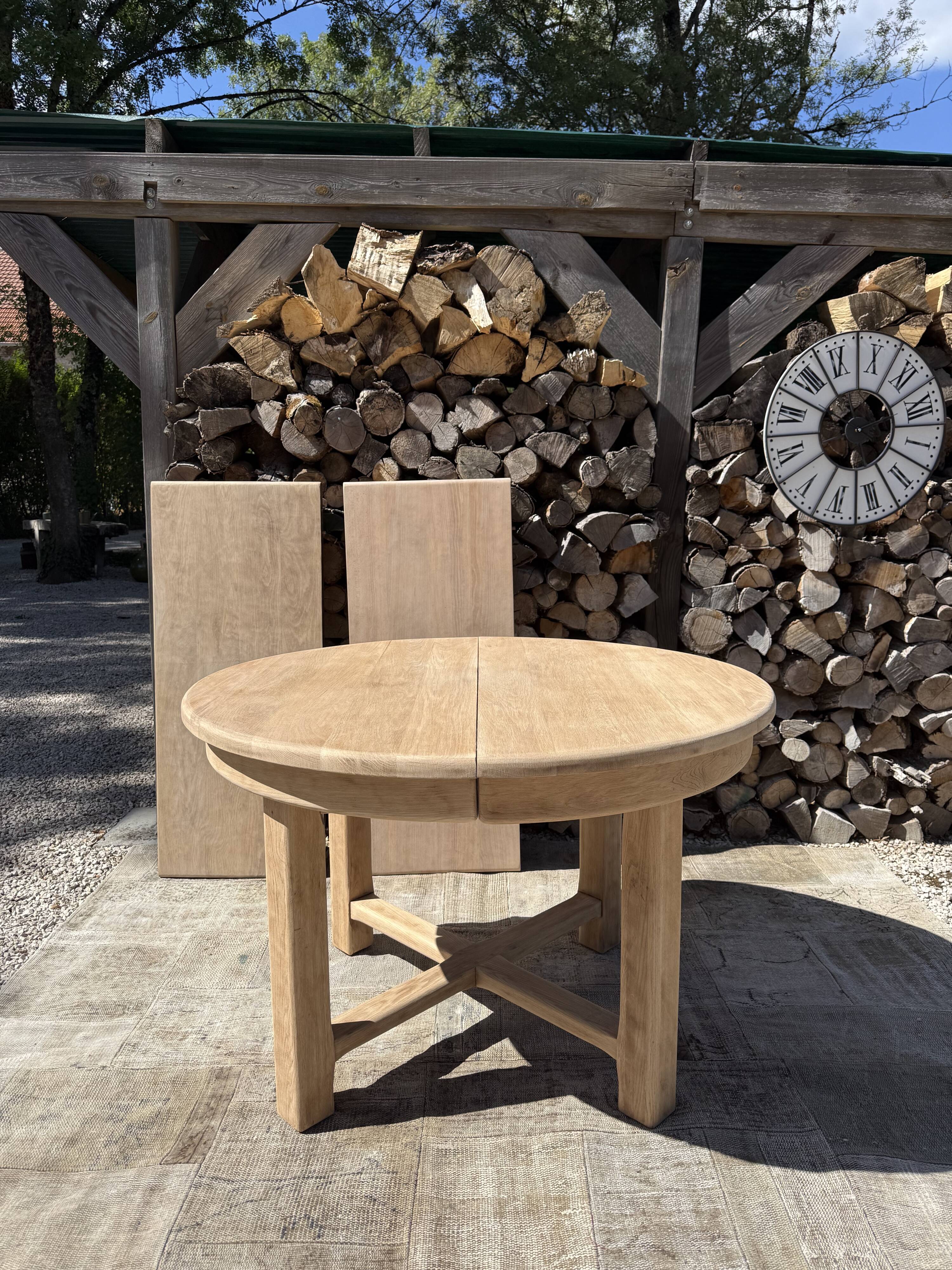 Round solid oak table with extensions, maximum 220cm.