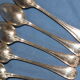 Old box of 12 small white metal spoons