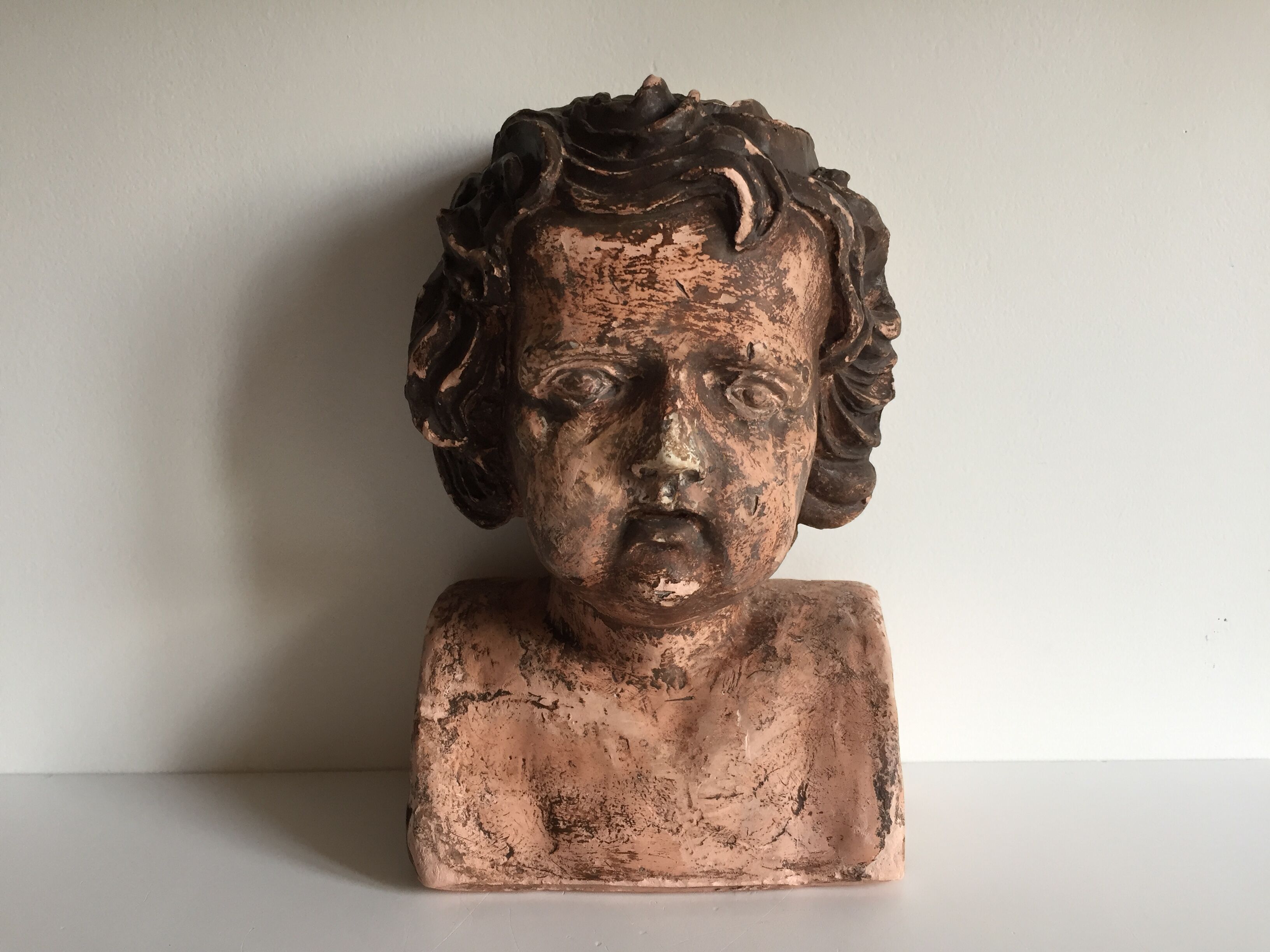 Bust old child in plaster stamped l.j.c.