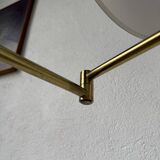 Floor lamp with articulated arm in brass-plated metal