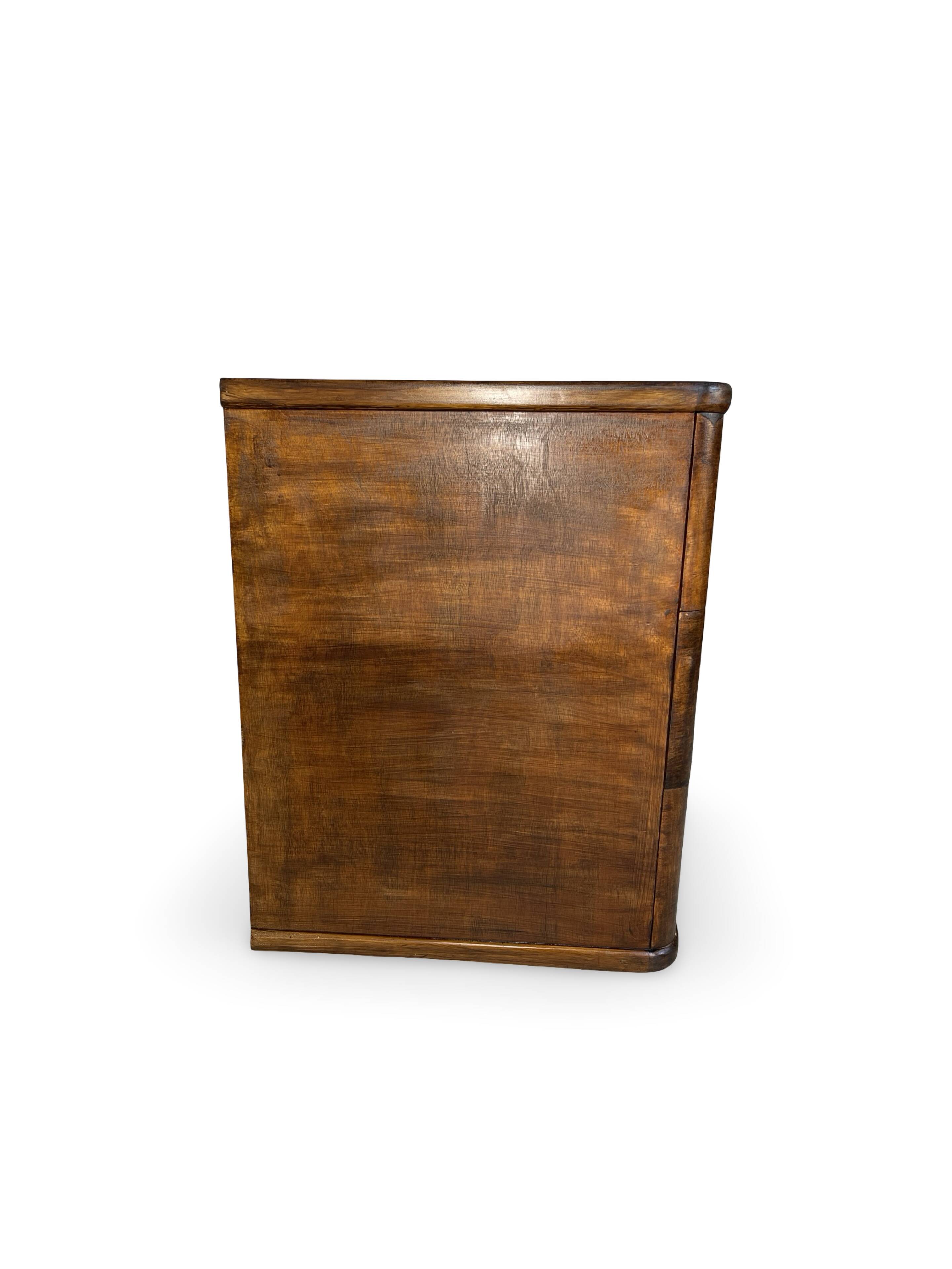 A vintage Italian chest of drawers, made of veneered walnut and solid wood,