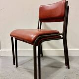 Pair of vintage stacking chairs with red vinyl upholstery