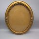 Old oval frame in wood and gilded stucco