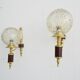 Golden wall lamps with round glass shades and teak veneer