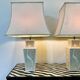 Pair of large cream ceramic table lamps with relief peacocks and fabric shades
